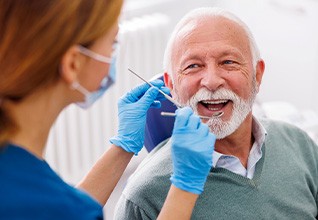 Man smiles at dentist