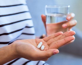 Lady prepares to take pills