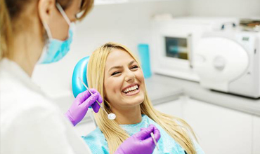 Laughing woman in dental chair