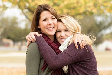 Mother and daughter smiling