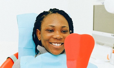 Woman looking in dental mirror