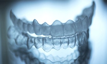 Pair of clear aligners used for orthodontics.