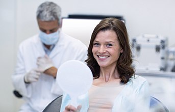 woman smiling and showing off her dental implants in Chevy Chase