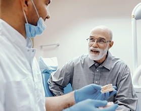 elderly man at a dental implant consultation