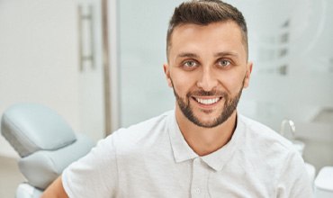 Bearded man smiling at the dentist’s office