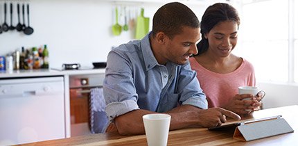 Man and woman looking at tablet