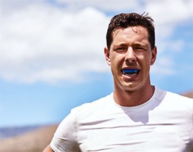Man wears athletic mouthguard