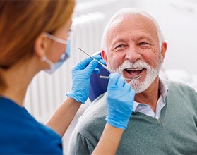 Man smiles at dentist