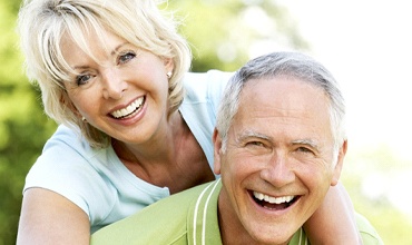 elderly couple holding each other 