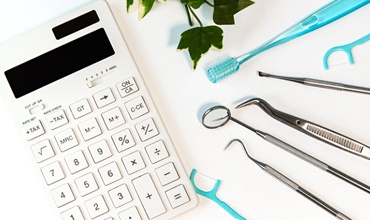 Dental tools lying next to calculator