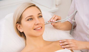 Young woman receiving microdermabrasion