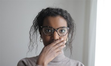 Woman covering her mouth with her hand