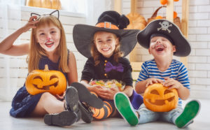 Halloween kids in costume candy and pumpkins