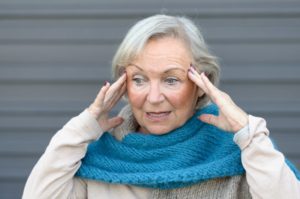 older woman confused holding head