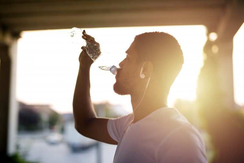 athlete drinking water after exercising